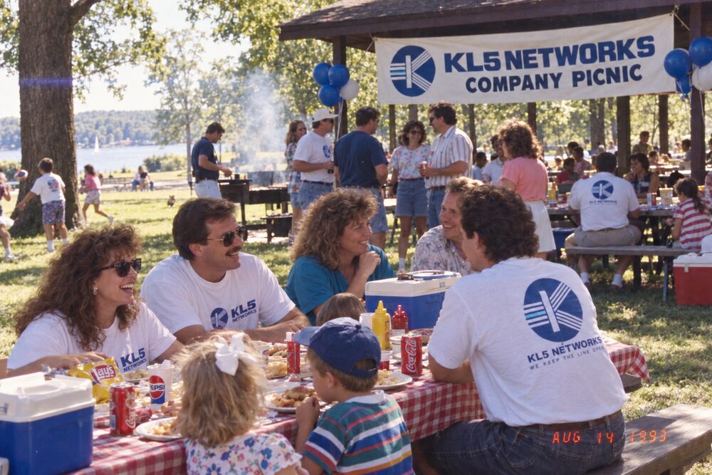 Families at a picnic table under the pavilion