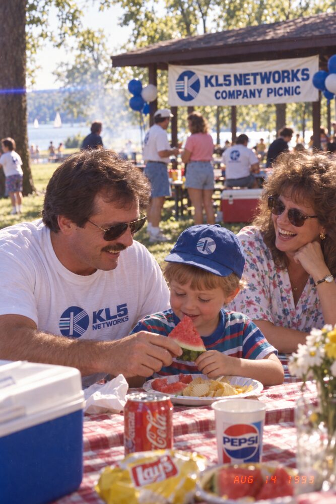 A family at a picnic table with drinks