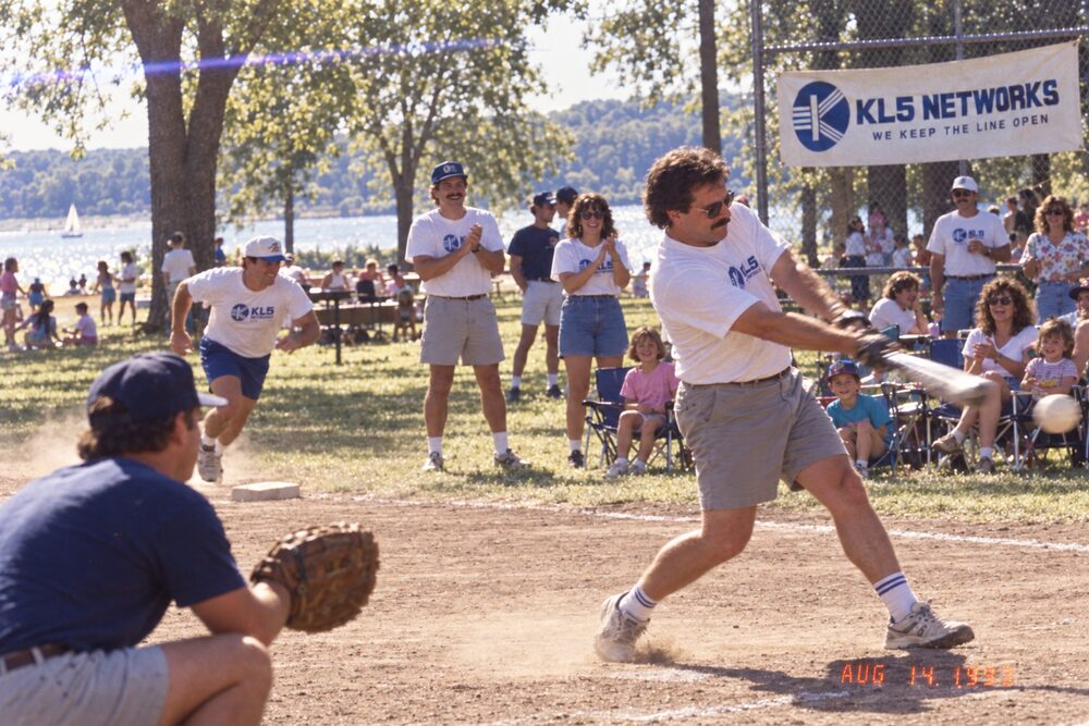 A softball batter mid-swing