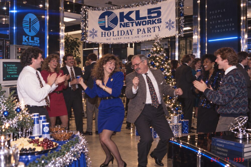 Colleagues dancing under the party banner