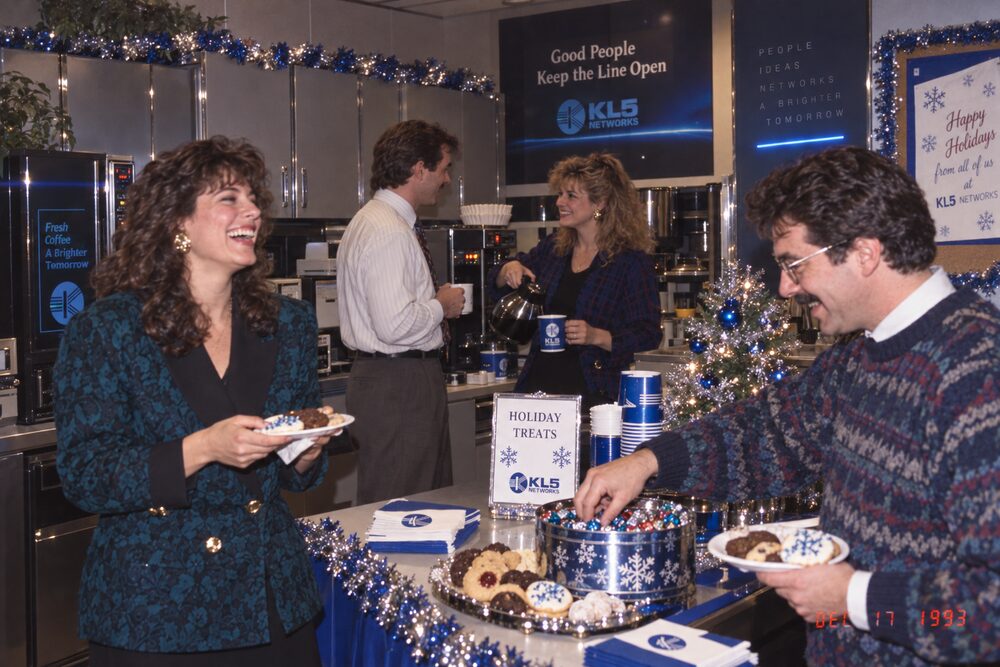 Two colleagues talking by the buffet