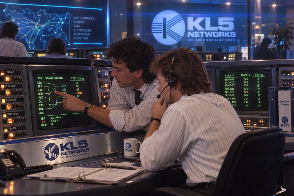 Two colleagues reviewing a screen together