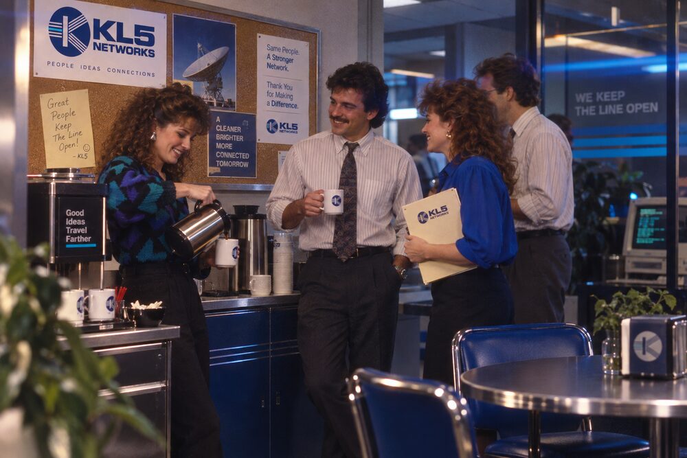 Colleagues in the lobby with a parcel